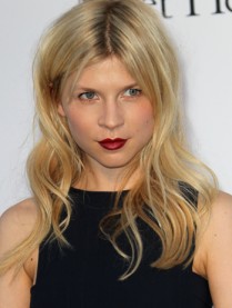 Clemence Poesy wearing a classic black dress and signature redvia Google Images